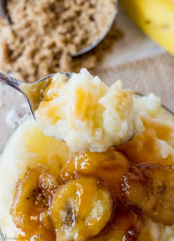 Spoon holding up some Bananas Foster Rice Pudding