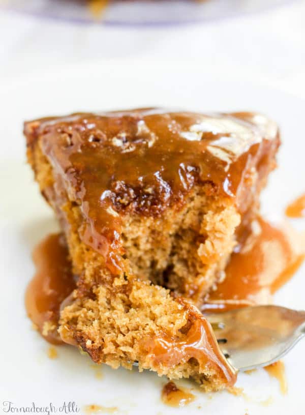 Brown Sugar Toffee Poke Cake on plate with fork holding a bite