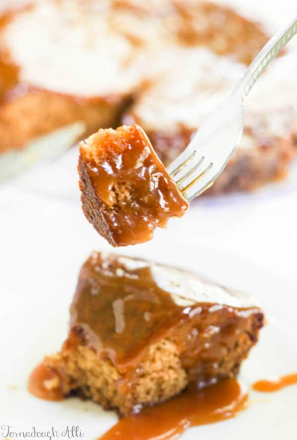 Fork holding up a piece of Brown Sugar Toffee Poke Cake