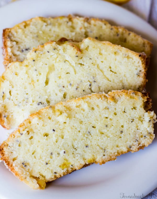 Overhead of three slices Candied Orange Chia Seed Bread on white plate