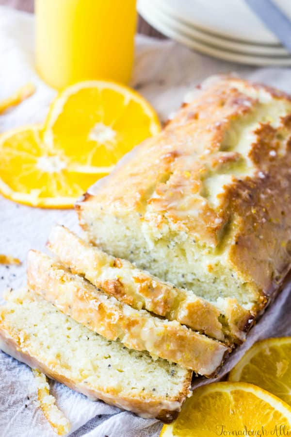 Sliced Candied Orange Chia Seed Bread on platter with oranges
