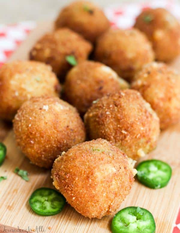 Copycat Texas Roadhouse Rattlesnake Bites on wooden board with sliced jalapeño 