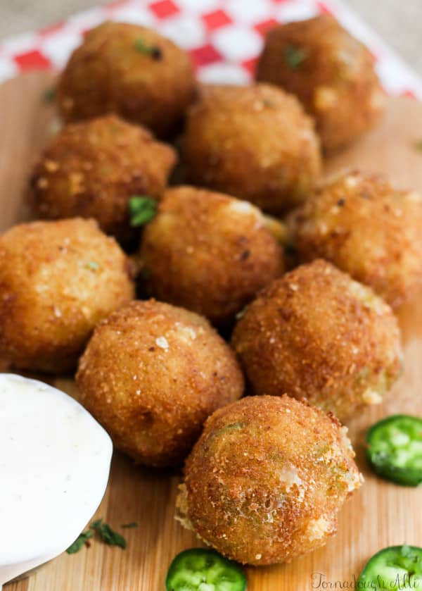 Copycat Texas Roadhouse Rattlesnake Bites on wooden board next to cup of ranch 