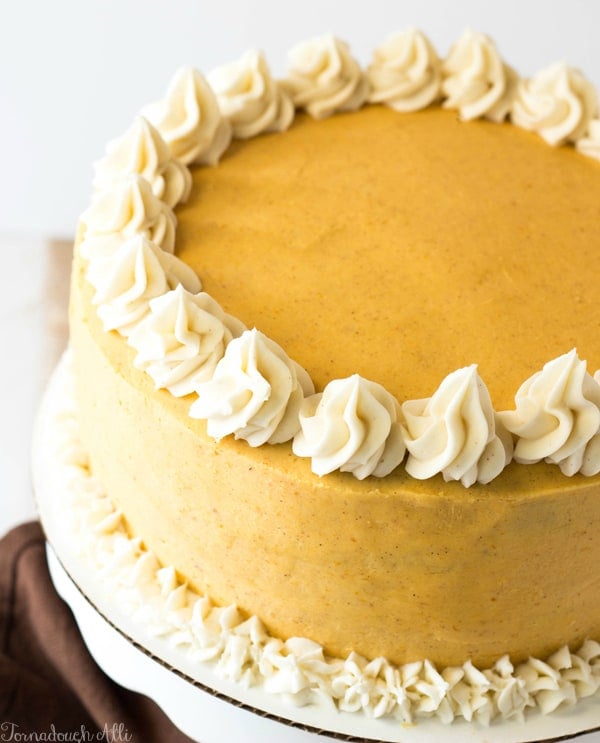 Spice Cake with Cinnamon Cream Cheese and Pumpkin Buttercream on cake stand