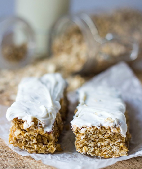 Two Strawberry Banana Granola Bars on parchment paper