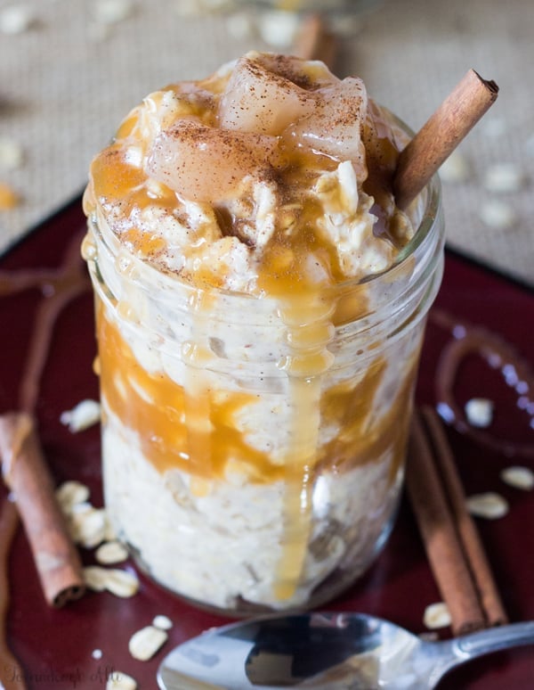 Caramel Apple Pie Overnight Oats on red plate with caramel and cinnamon stick