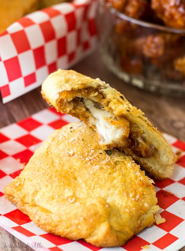 BBQ Chicken Pizza Pockets sliced and stacked with bite taken out of one