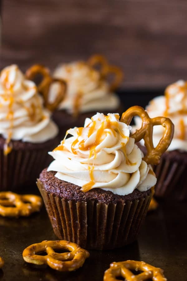 Chocolate Stout Pub Cupcakes drizzled with caramel and pretzel in frosting