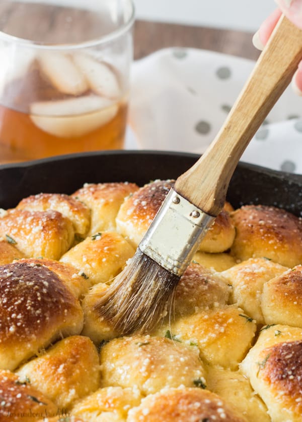 Butter being brushed over Bacon Jalapeo Popper Stuffed Monkey Bread