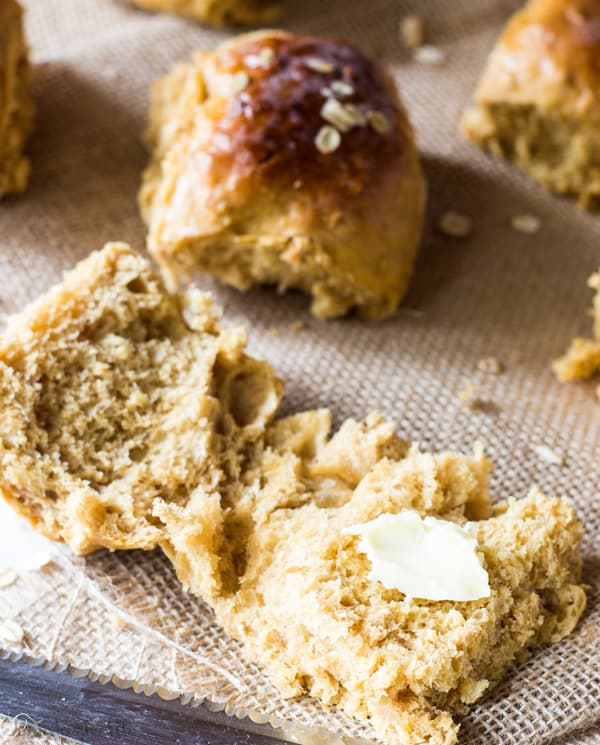 Oatmeal Molasses Bread roll open with pat of butter