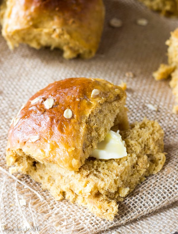 Oatmeal Molasses Bread Roll closed with butter sticking out