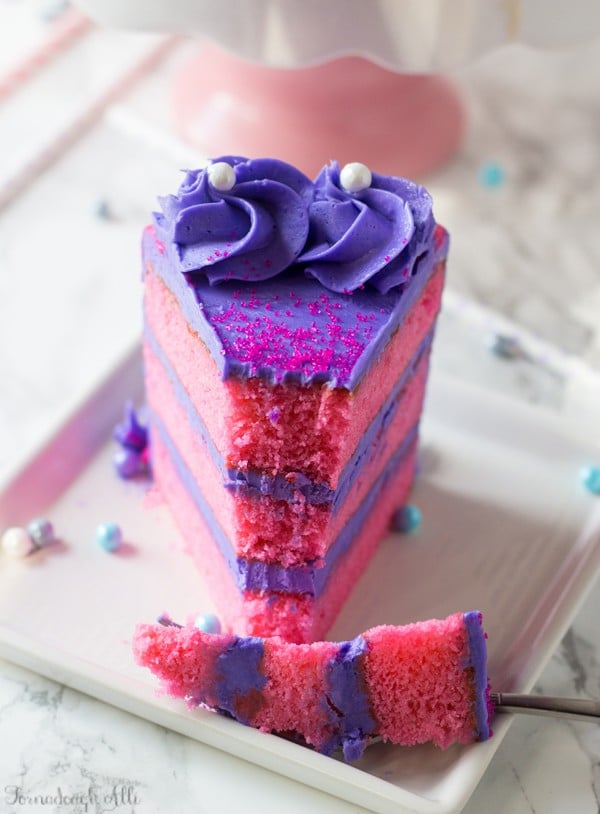 Pink Velvet Cake with fork holding bite taken out