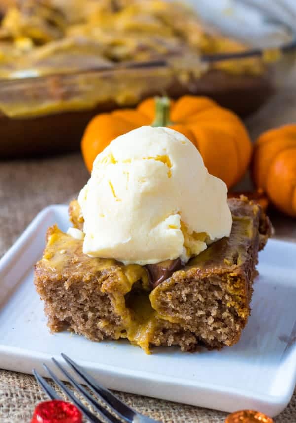 Slice Caramel Pumpkin Spice Earthquake Cake on white plate topped with ice cream