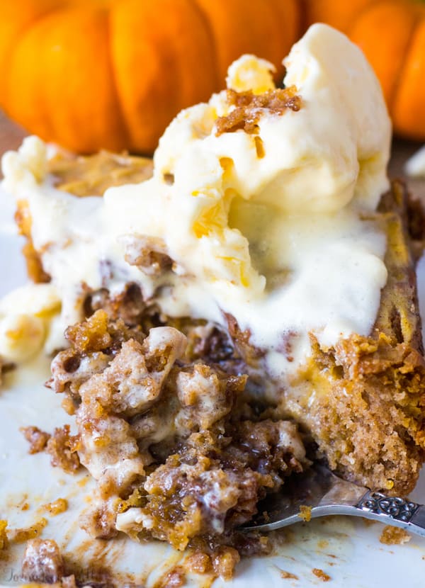 Caramel Pumpkin Spice Earthquake Cake on plate with fork showing gooey middle