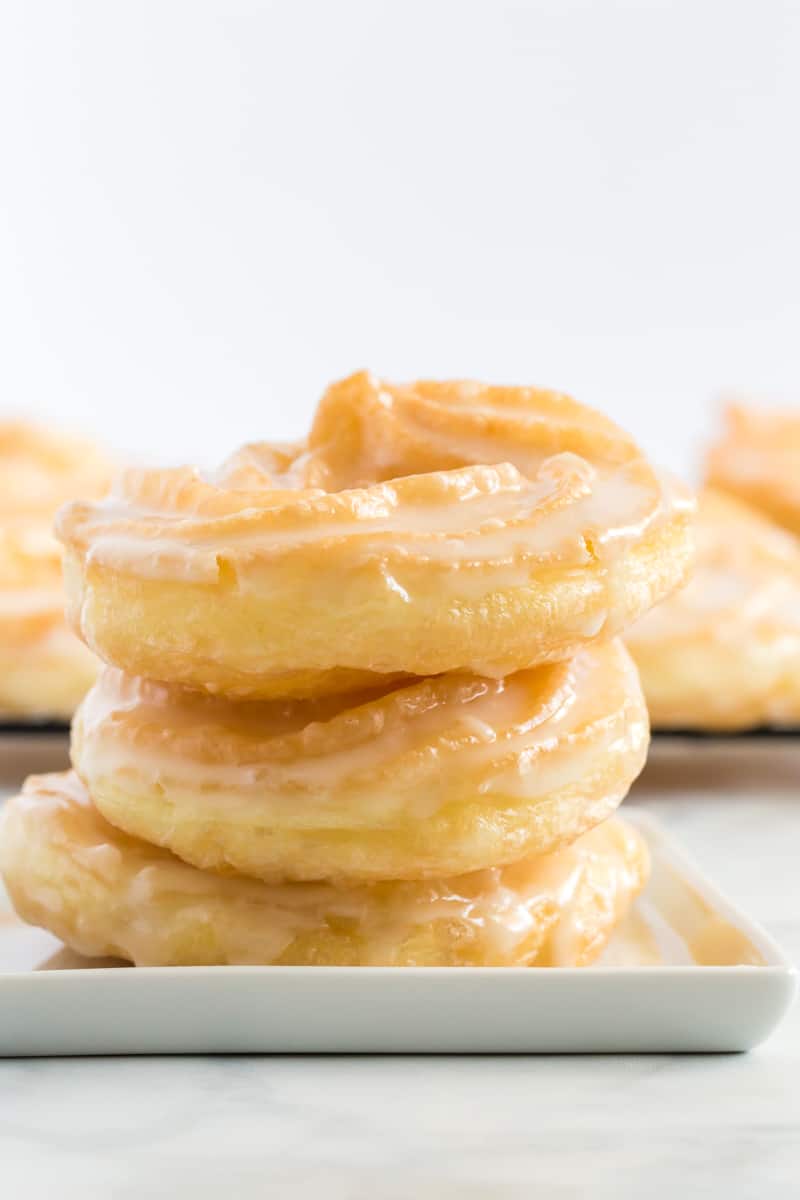 Stacked and glazed crullers on plates