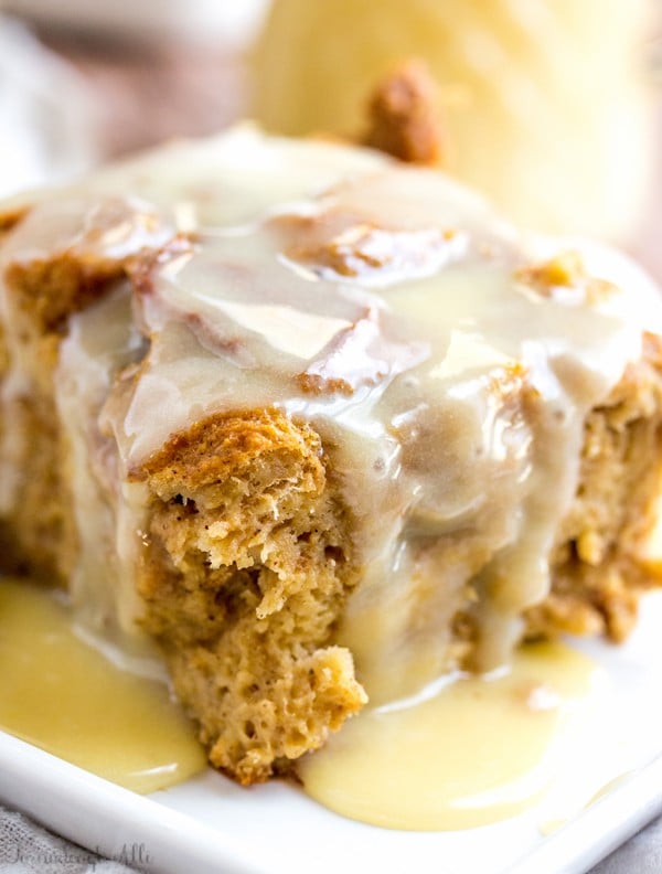 Gingerbread Bread Pudding covered in sauce on plate