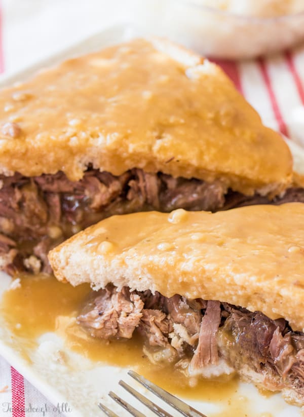 Two slices of Roast Beef Commercial on plate covered with gravy