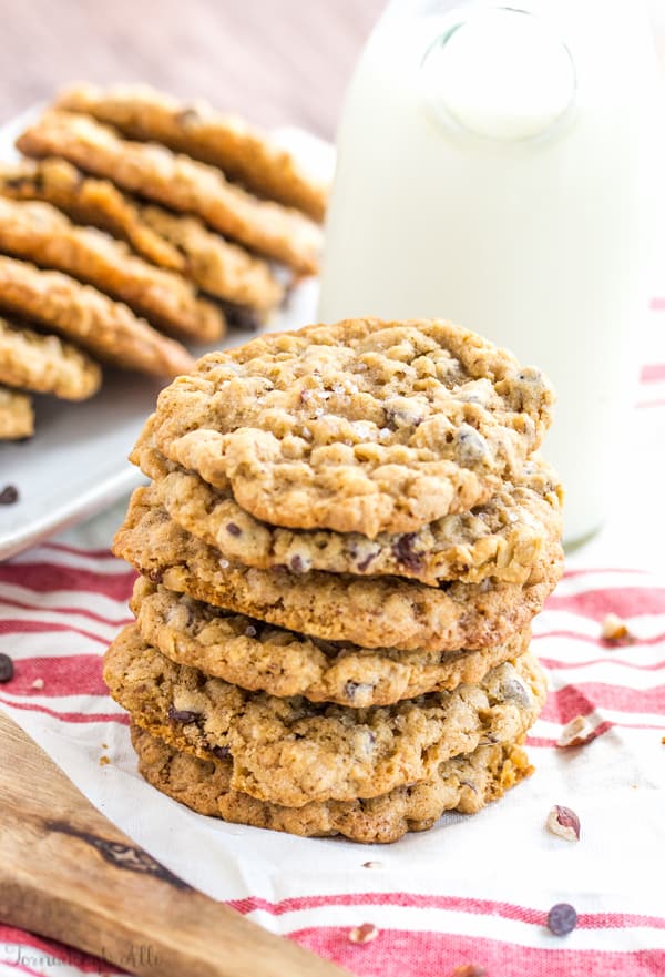 Sea Salt Hazelnut Chocolate Chip Oatmeal Cookies stacked with cookies on white platter in background