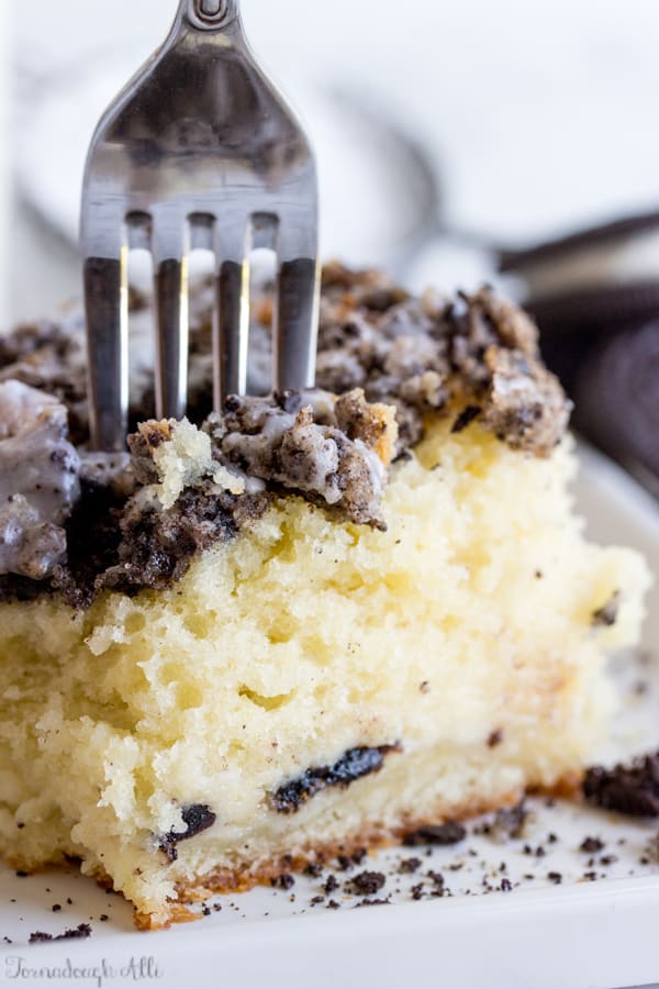 Fork going into Cookies and Cream Coffee Cake on white plate