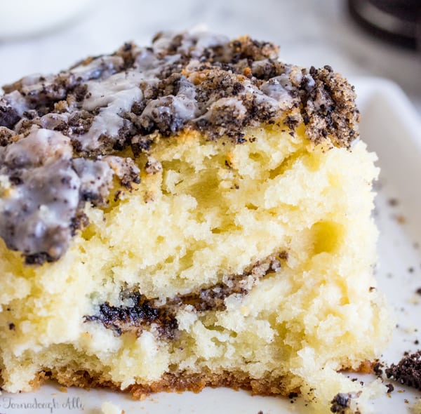 Bite taken out of Cookies and Cream Coffee Cake on white plate