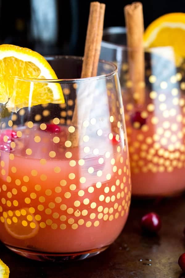 Two Cranberry Orange Mimosas in stemless wine glasses