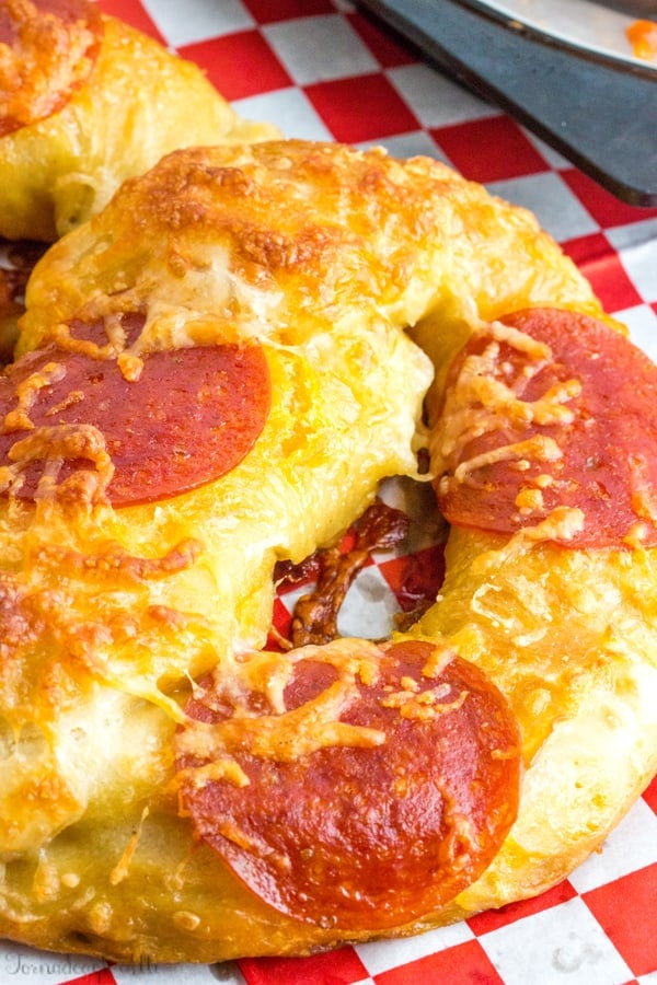 Close up of pepperoni and cheese on pretzel