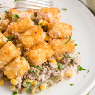 Plated tater tot hotdish topped with diced parsley