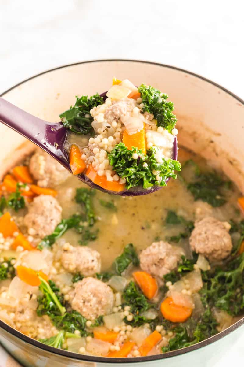 Italian Wedding Soup in pot finished with some on a serving spoon
