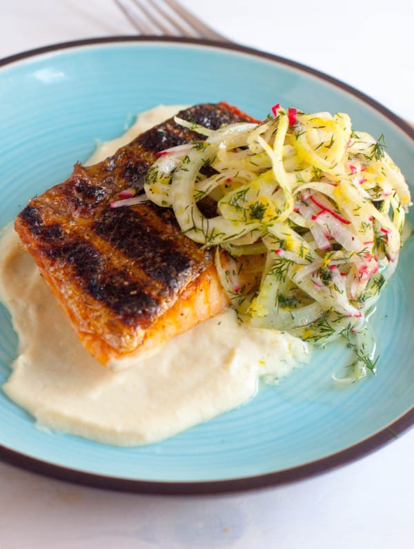 Grilling is a summer staple activity. Cooking this easy grilled salmon dish is simple and delicious, especially with a silky smooth corn puree and a crisp, but light, fennel salad.