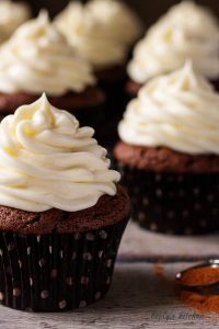 Lightly spiced double chocolate cupcakes combine peppery cayenne seasoning with rich dark chocolate and decadent white chocolate buttercream frosting.