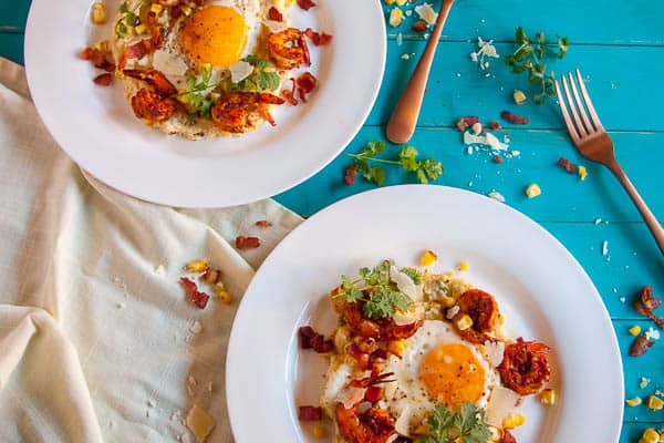 This Spiced Shrimp and Creamy Polenta is a classed-up version of the classic Shrimp and Grits. With roasted corn and topped with a fried egg, this dish is comfort food to the max.