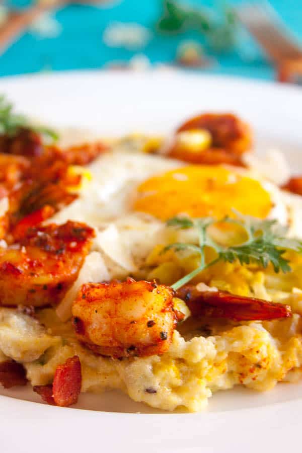 This Spiced Shrimp and Creamy Polenta is a classed-up version of the classic Shrimp and Grits. With roasted corn and topped with a fried egg, this dish is comfort food to the max.