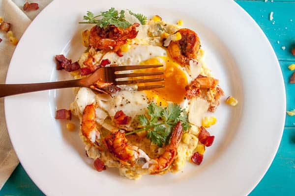 This Spiced Shrimp and Creamy Polenta is a classed-up version of the classic Shrimp and Grits. With roasted corn and topped with a fried egg, this dish is comfort food to the max.