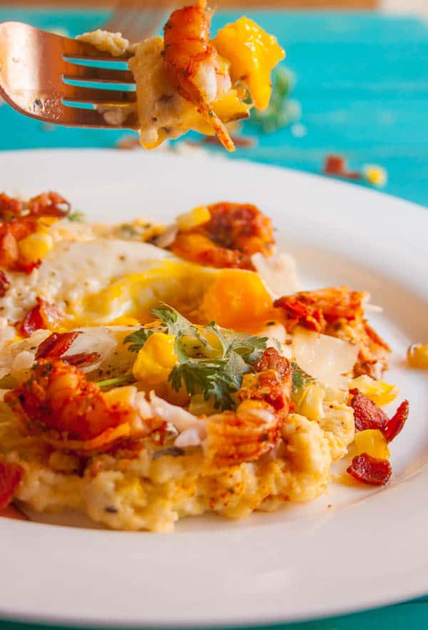 This Spiced Shrimp and Creamy Polenta is a classed-up version of the classic Shrimp and Grits. With roasted corn and topped with a fried egg, this dish is comfort food to the max.