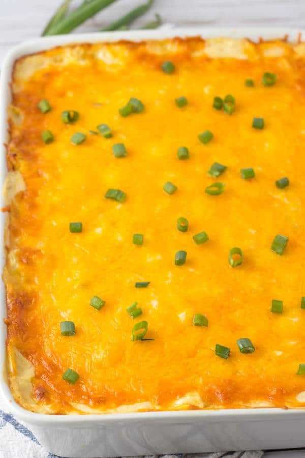 chicken tortilla casserole in pan with green onions
