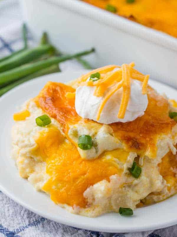 chicken tortilla casserole on plate with sour cream