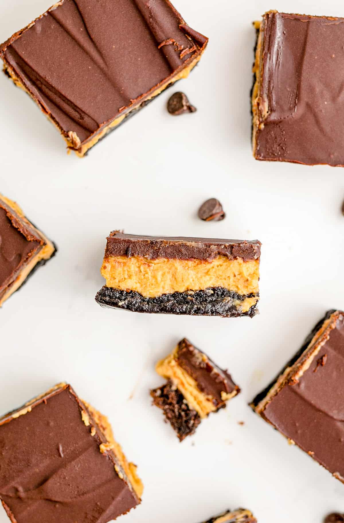 Overhead photo of one brownie on its side showing the brownie, peanut butter and ganache layers.