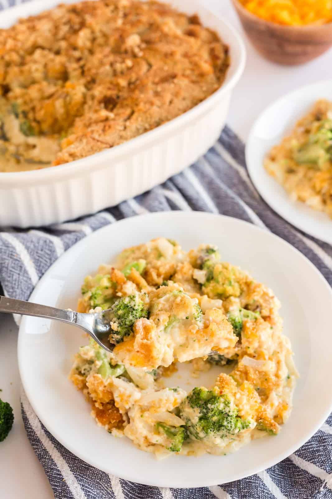 Fork holding up small amount of broccoli casserole