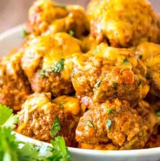 Enchilada meatballs stacked on white plate