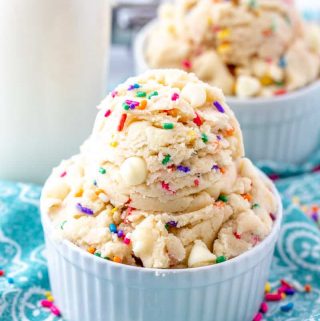 Two bowls full of edible cookie dough showing white chocolate and sprinkles