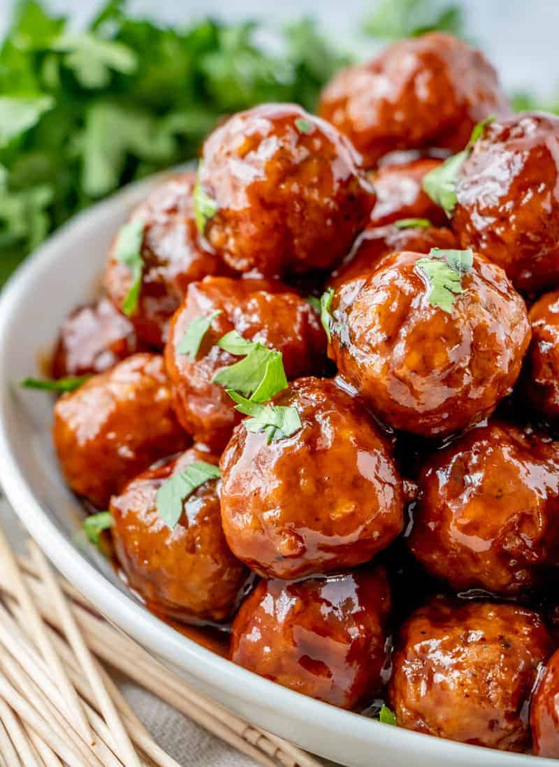 Honey BBQ Crockpot Meatballs stacked on plate