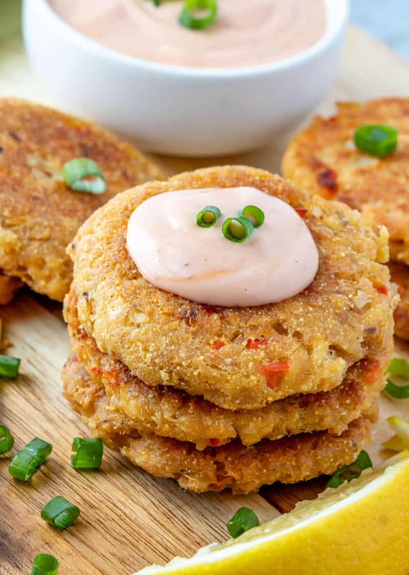 Salmon patties stacked with lemons