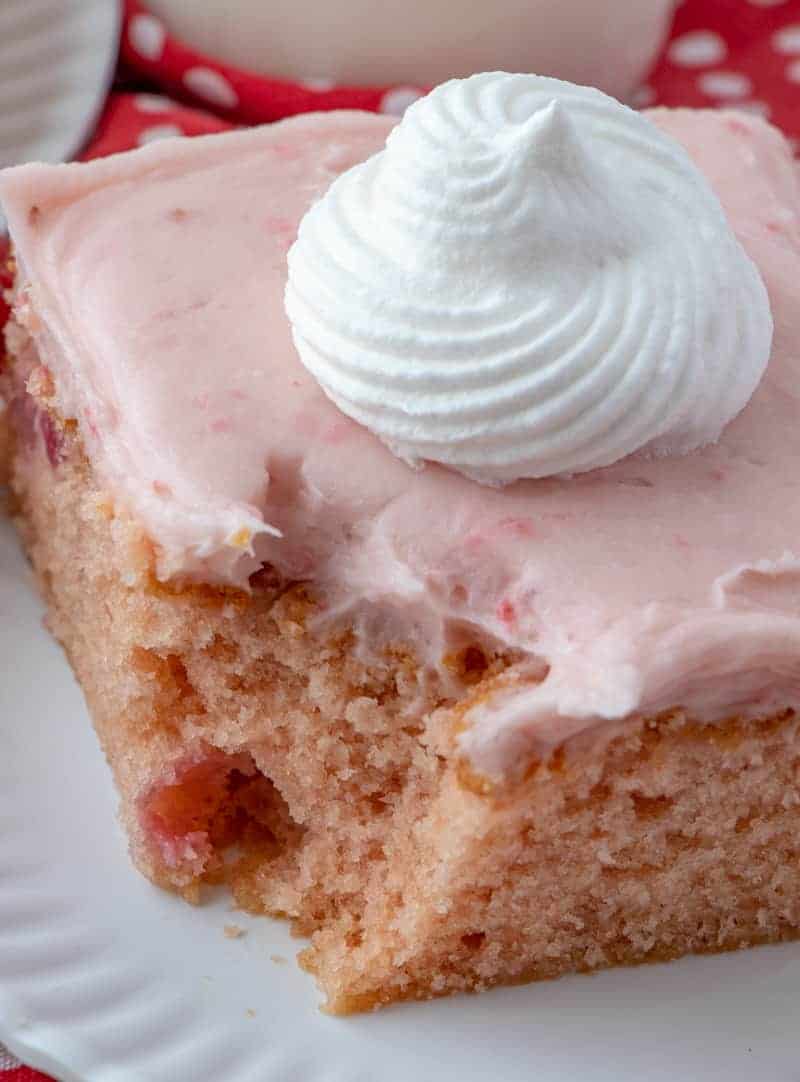 Strawberry cake on plate with bite taken out