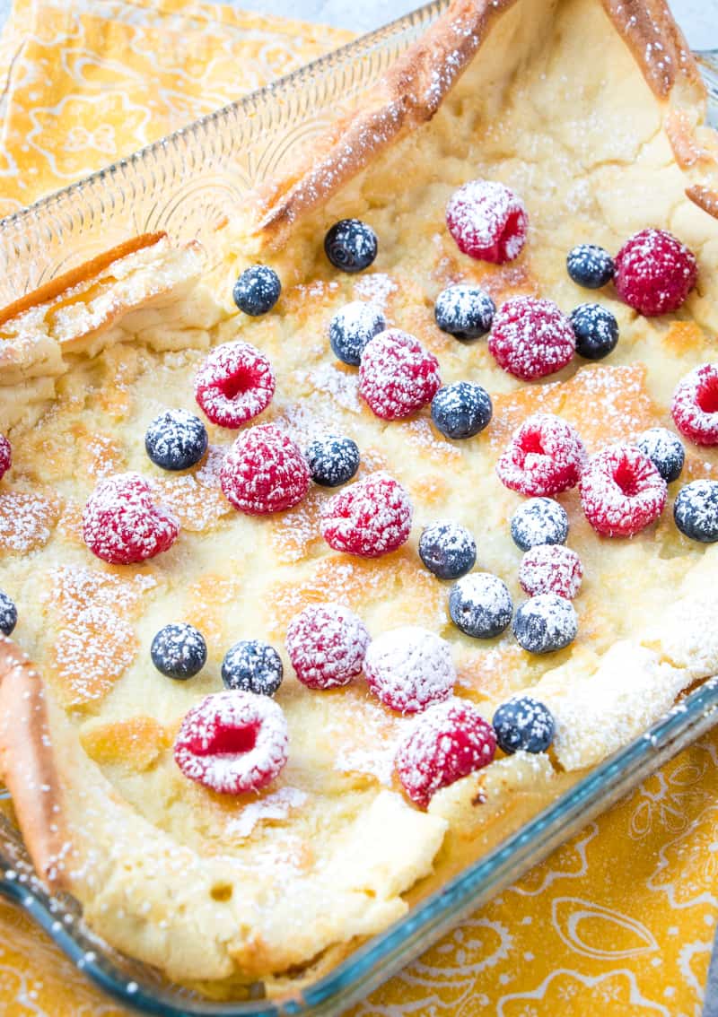 German Pancake in dish with berries and powdered sugar