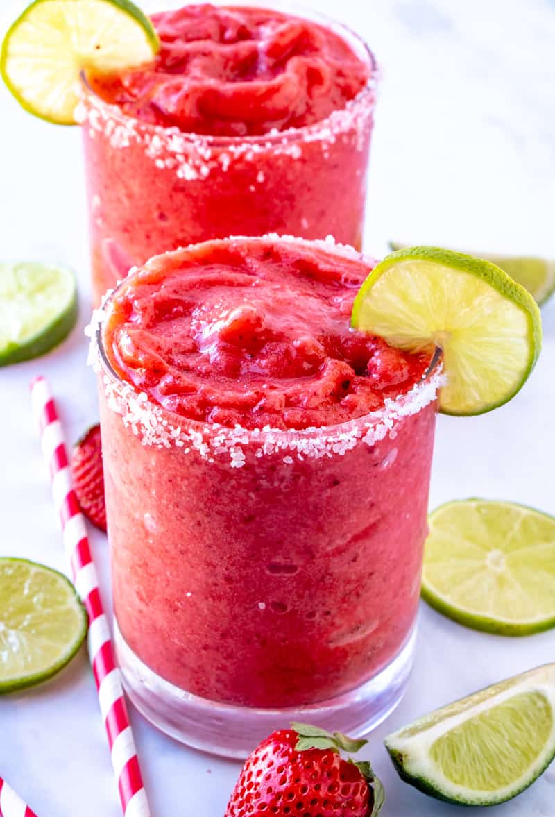 Strawberry Margaritas in salt rimmed glass with lime slices