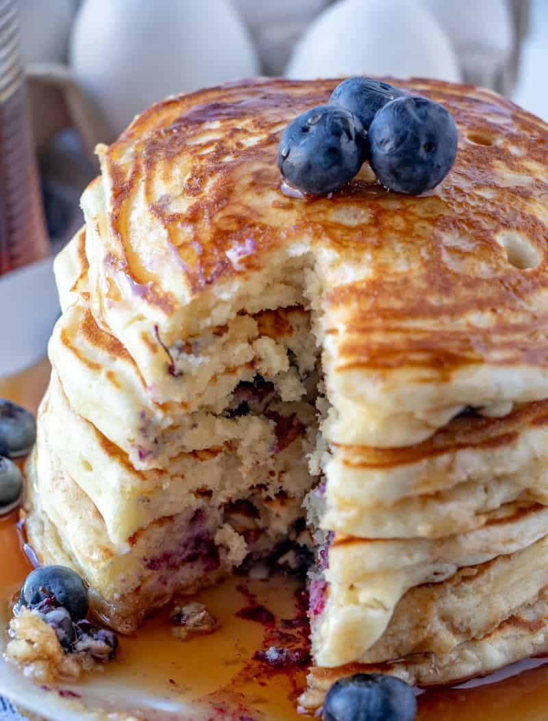 Bites taken out of stack of blueberry pancakes seeing inside 