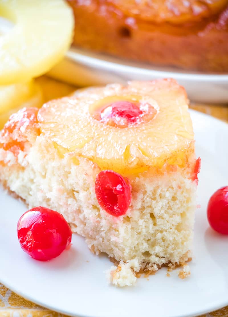Slice of Pineapple Upside Down Cake on plate with bite taken out