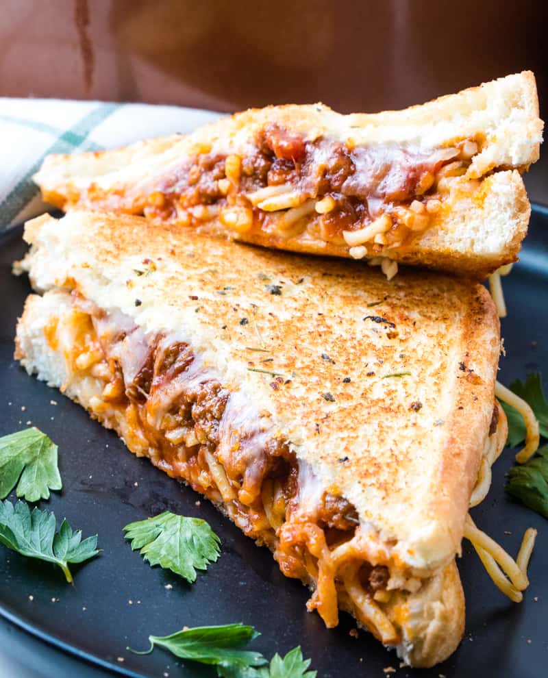 Close up side shot of spaghetti sandwich sliced on plate