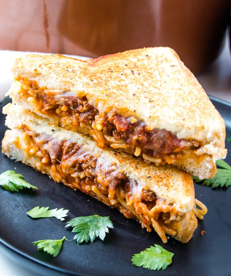 Spaghetti Sandwich on black plate cut in half