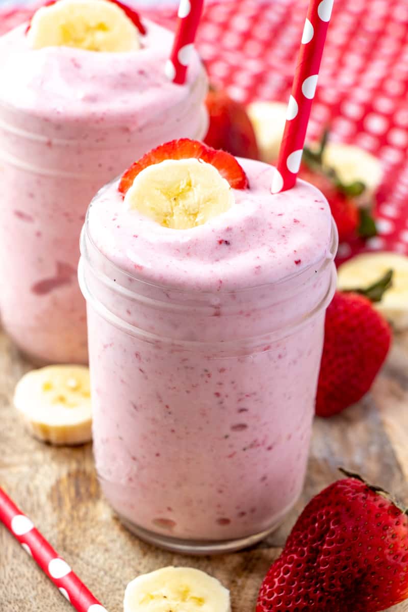 Close up of smoothies in jars on wooden board